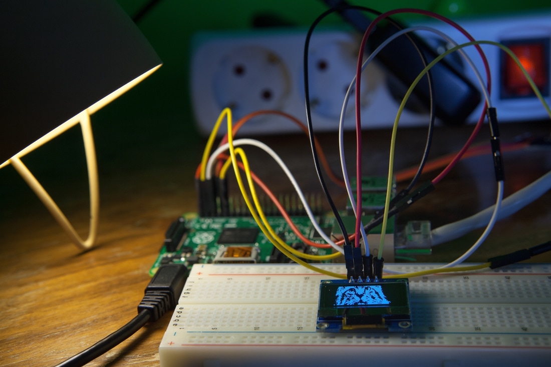 Embedded prototype: a Raspberry Pi wired to a breadboard and OLED display